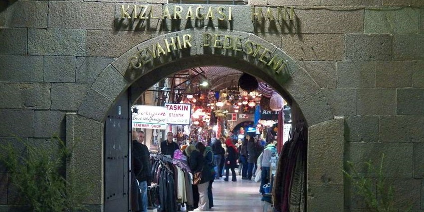 An image of an Ottoman-era caravanserai in İzmir's Kemeraltı Bazaar, now a lively traditional market.