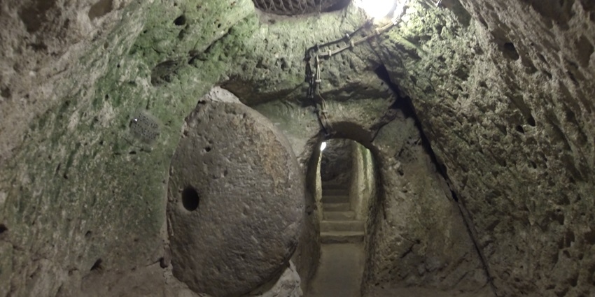 Interior passage of Derinkuyu Underground City with stone corridors and chambers—things to do in turkey