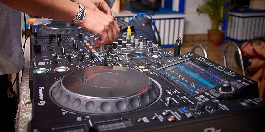 Image of a DJ with the system for music - Creative venue blending art, music, and a vibrant crowd