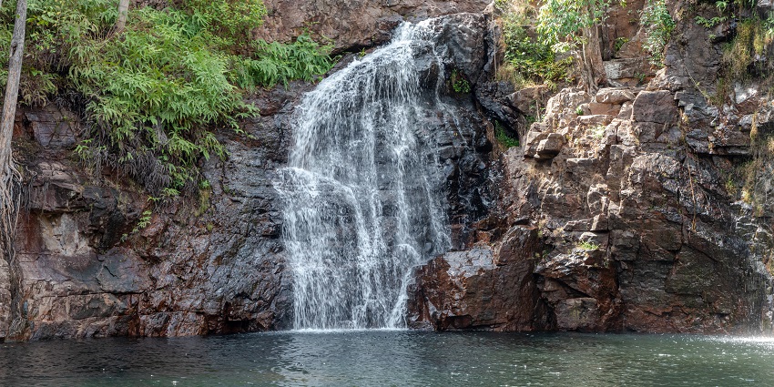 Image of Florence waterfall in Australia is surrounded by monsoon forest