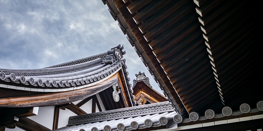 A traditional pagoda roof in a popular temple in Canada with wooden beams and architectural lines.