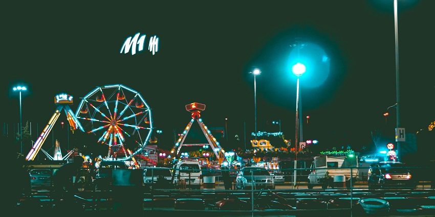 A view of an illuminated amusement park in Canada, showcasing colourful lights.