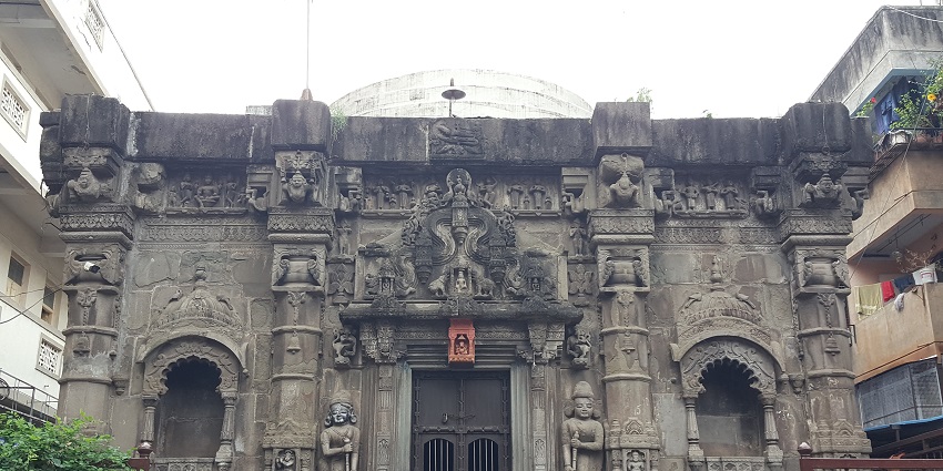 -An image of Ganesh Mandir with an entrance adorned with circular reliefs set into pillars.