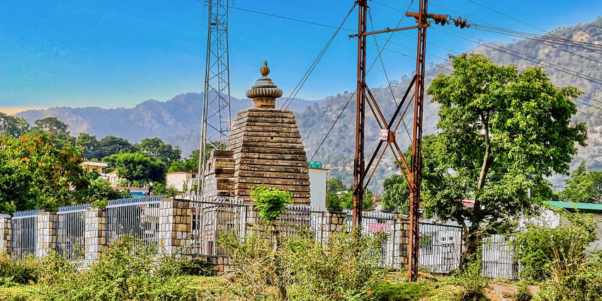 Sacred temple perched on a rock, attracting many devotees.