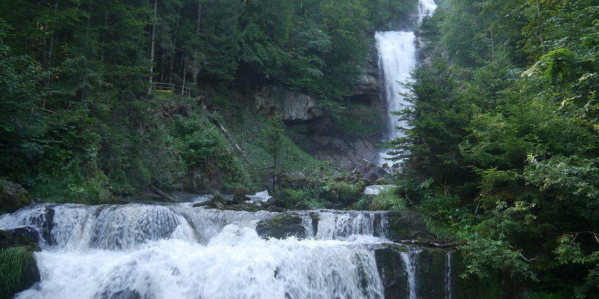 Image of Majestic waterfall cascading into Lake Brienz with scenic trails