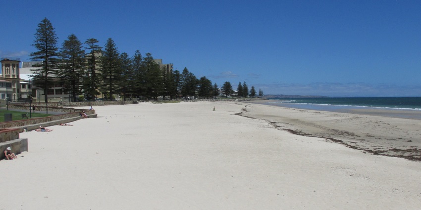 People relaxing on Glenelg Beach, one of the beaches in Adelaide