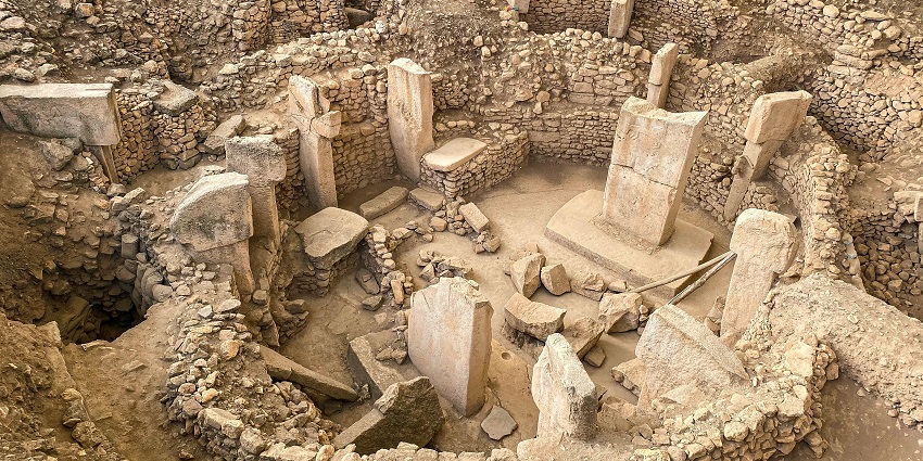 Gobekli Tepe, a prehistoric archaeological site with massive stone pillars and carvings.