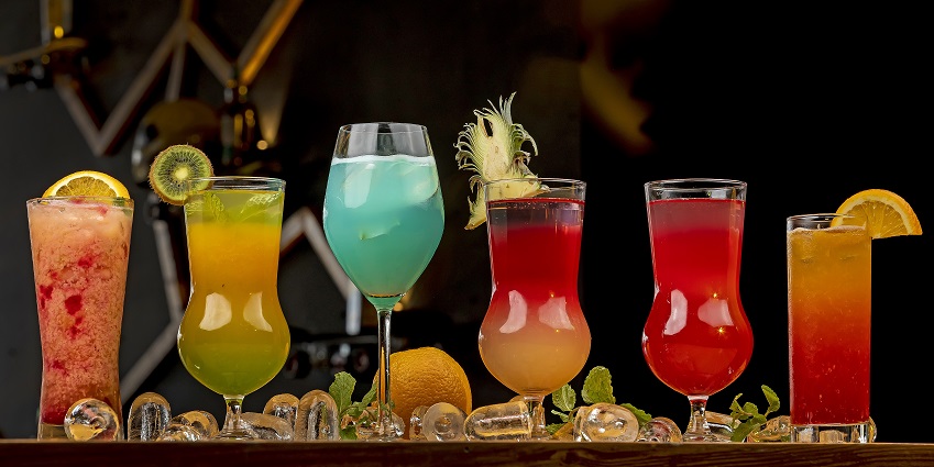 An image of a woman drinking cocktail in Good Fortune Bar, a famous bar.