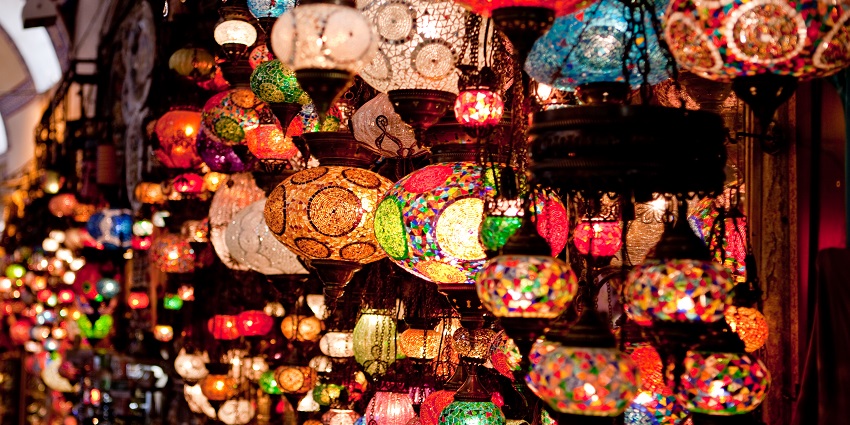 Historic covered market with shops selling antiques, textiles, and souvenirs.
