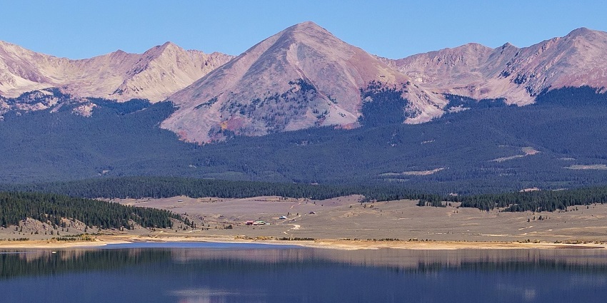 A view of Grizzly Peak with rugged terrain and rocky slopes under a clear blue sky