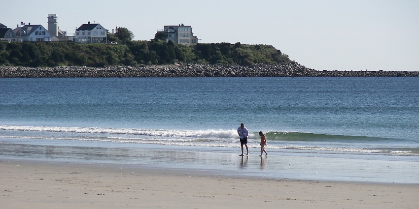 A family enjoying the waves of Hampton Beach.