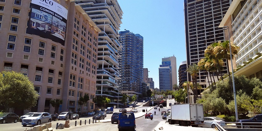 Bustling street with shops, cafes, and vibrant city life.
