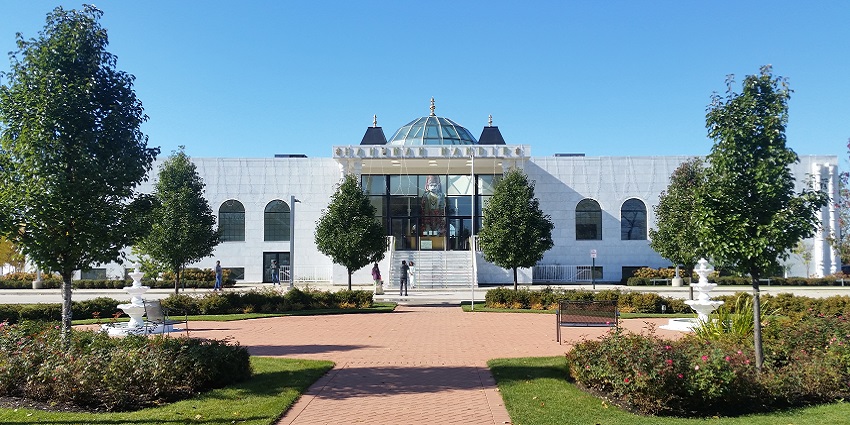 An image of a Hanuman Mandir of Greater Chicago temple building with a large white tower.