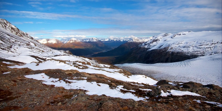 An image of the vast, frozen expanse of Harding Icefield stretches across rugged Alaskan terrain