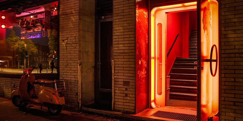 The entrance gate with multiple vibrant lights and a scooter parked next to the gate