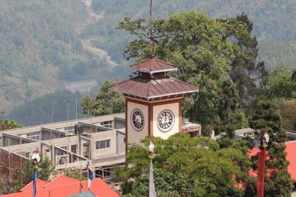 An image of Kalimpong town with dark clouds rolling over the scenic hills.