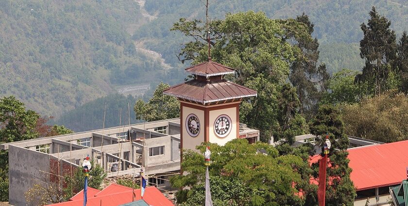 An image of Kalimpong town with dark clouds rolling over the scenic hills.