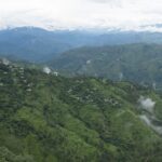 A picture of the breathtaking view of Himalayan hills and a serene lake in Kanpur.