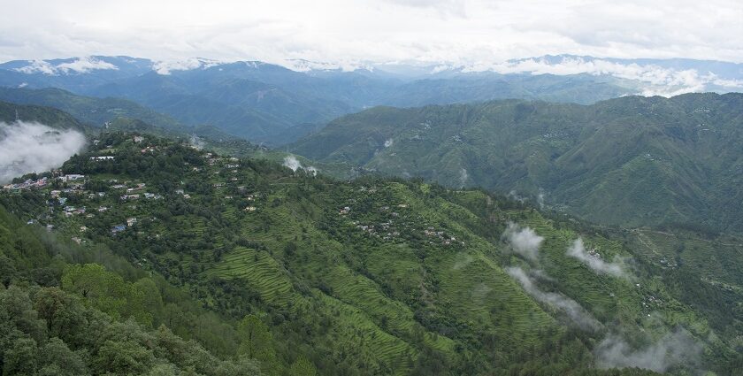 A picture of the breathtaking view of Himalayan hills and a serene lake in Kanpur.