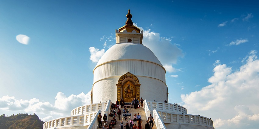 An image of a famous temple in Canada with detailed architecture and vibrant design, surrounded by greenery.