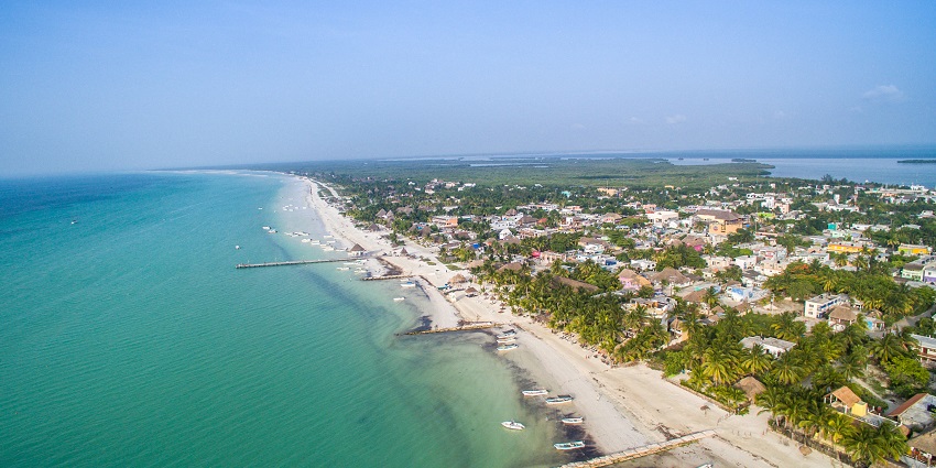 An aerial view of Holbox showcasing the meeting point of the land and a large water body