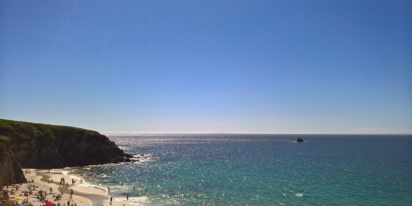 Picturesque view of beachside - Honfleur beach surrounded by lush greenery and clear water