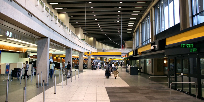 An exterior view of Calgary Airport, featuring modern architecture and clear skies.