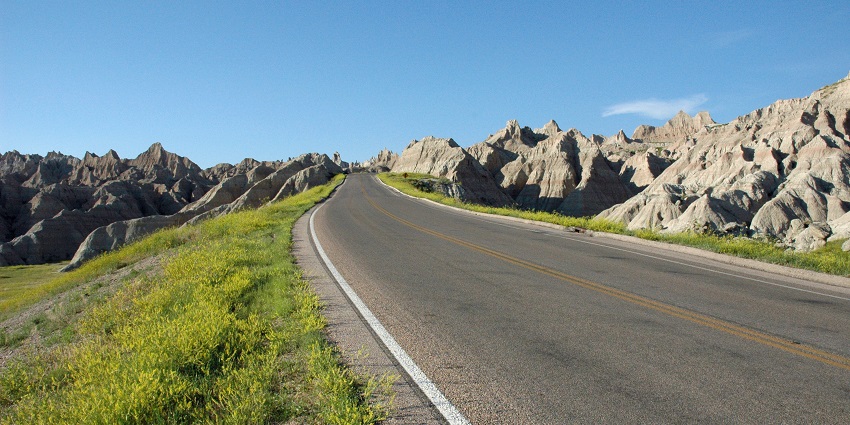 An image of a road looking up Badlands Loop Road near Toadstool Rock to reach Badlands National Park.