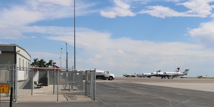 An aerial view of Northern Colorado Airport featuring a runway, taxiways, and terminal buildings.