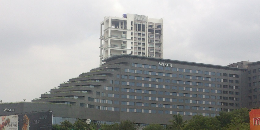 A picture of Koregaon park taken from a distance with trees and greenery visible