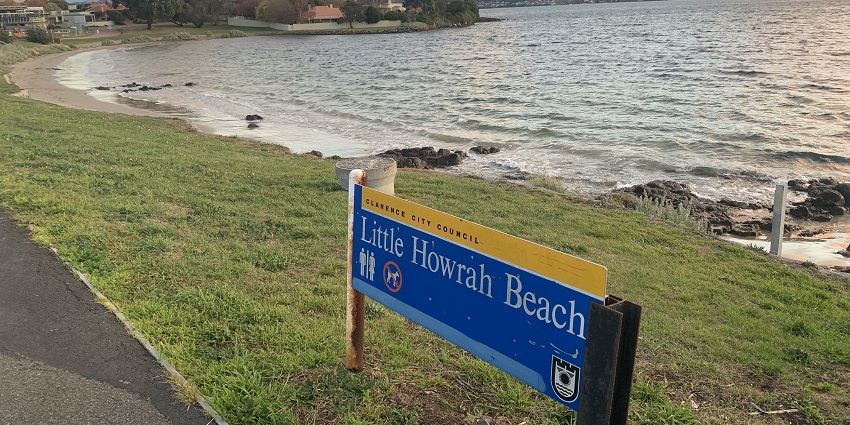 An entrance sign to Howrah Beach amidst a captivating backdrop.