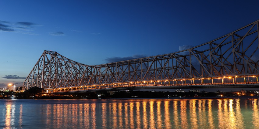 A picture of the iconic Howrah Bridge in Kolkata, taken during the twilight hour