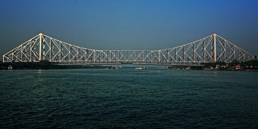 An image of Howrah Bridge offering stunning views of the landscape at sunset