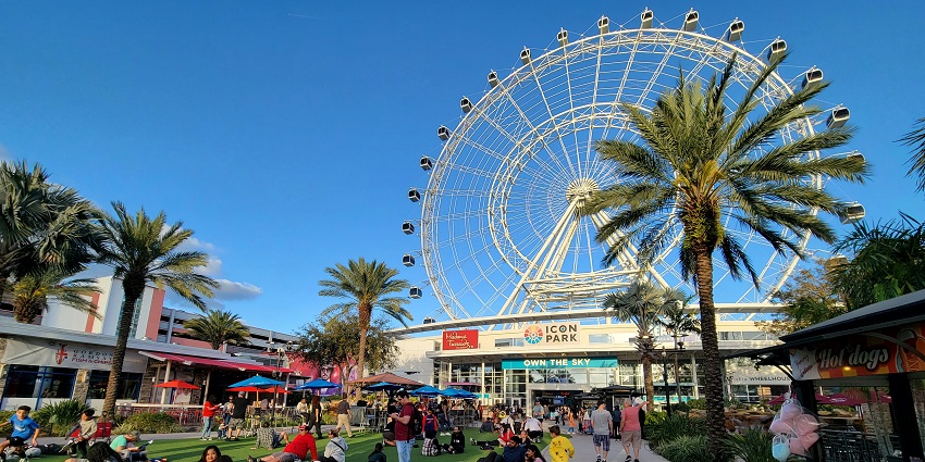 People relaxing on the lawn in front of the ICON PARK after roaming the park in Orlando.