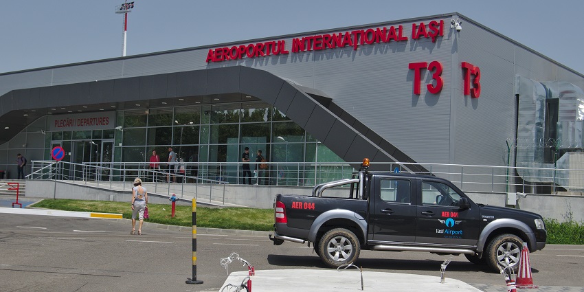 Outside of Terminal 3 building of Iași International Airport with an airport cop car