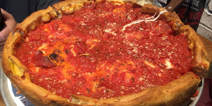 A delicious stuffed deep-dish pizza with chilli flakes served at a restaurant in California