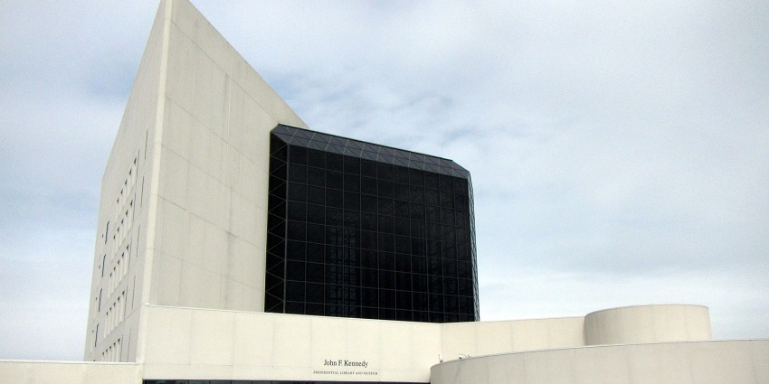The front view of the JFK Presidential Museum with white cones near the entrance