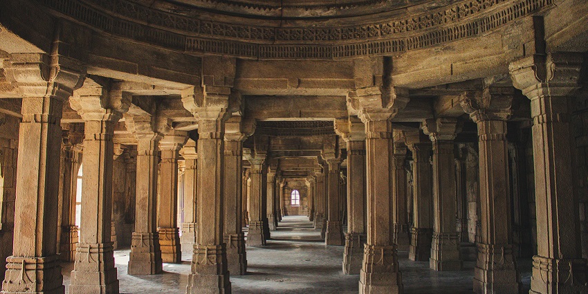 An image of brown concrete columns inside one of the Jain temples in Canada.