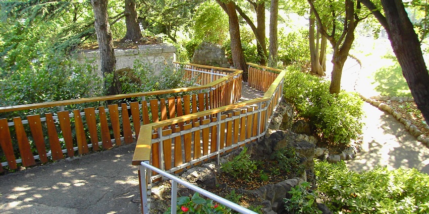 Scenic park with lush greenery, fountains, and panoramic views