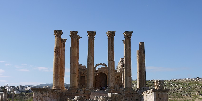 Ancient Roman city ruins with well-preserved columns and structures.