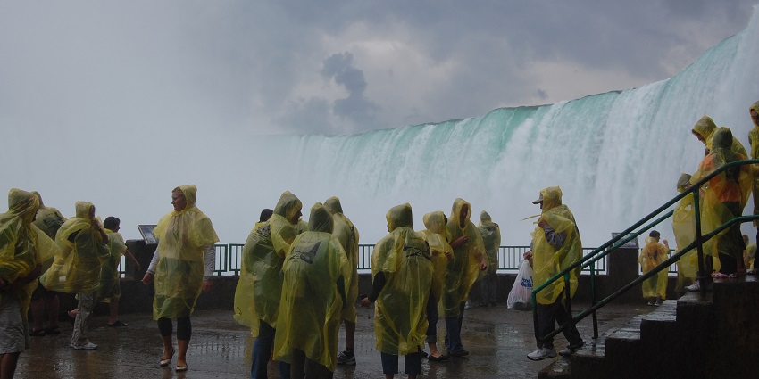 An image of visitors at Journey Behind the Falls experience a close-up of Niagara Waterfalls' powerful cascade