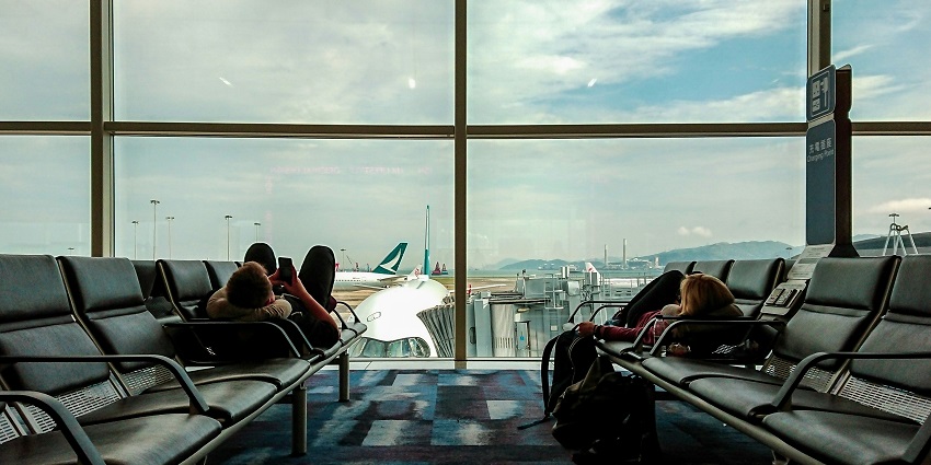 Gate of Kalamata International Airport with people taking out their luggage from the bus
