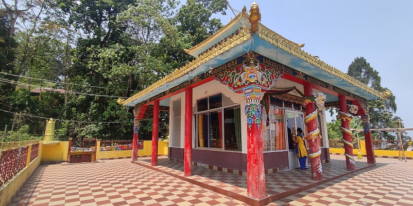 Image of Kalimpong Gompa with colourful prayer flags waving gently in the breeze.