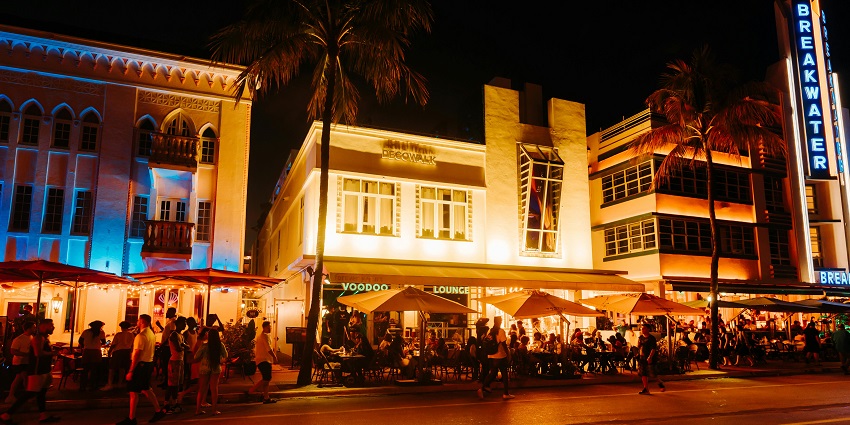 Image of vibrant nightlife with colourful lights and people walking around the street