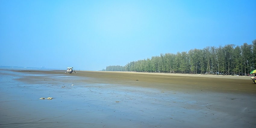 Tranquil daylight view of Parki Beach’s sandy shore framed by gentle sea-blue