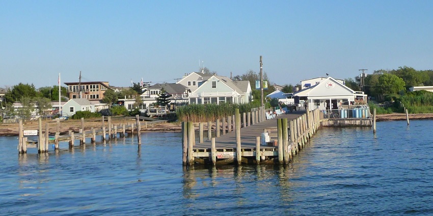 A panoramic view of a charming seaside with colourful houses and boats docked in the water