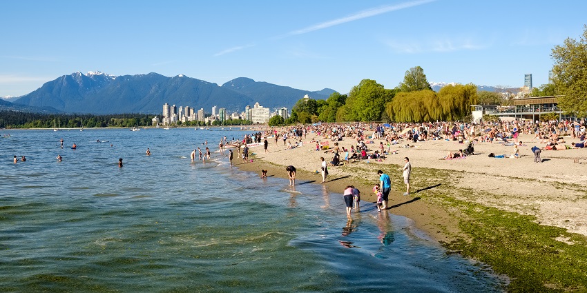 Some people are present in Kitsilano Beach and some are in the English Bay swimming