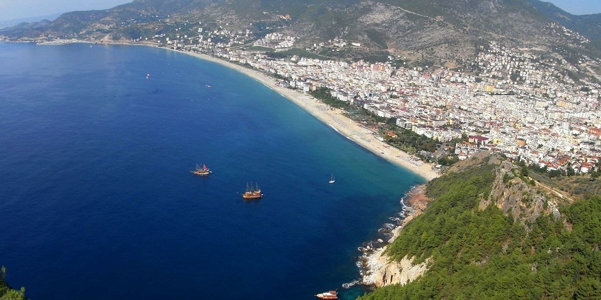 The beaches in Turkey with clear waters surrounded by lush greenery.