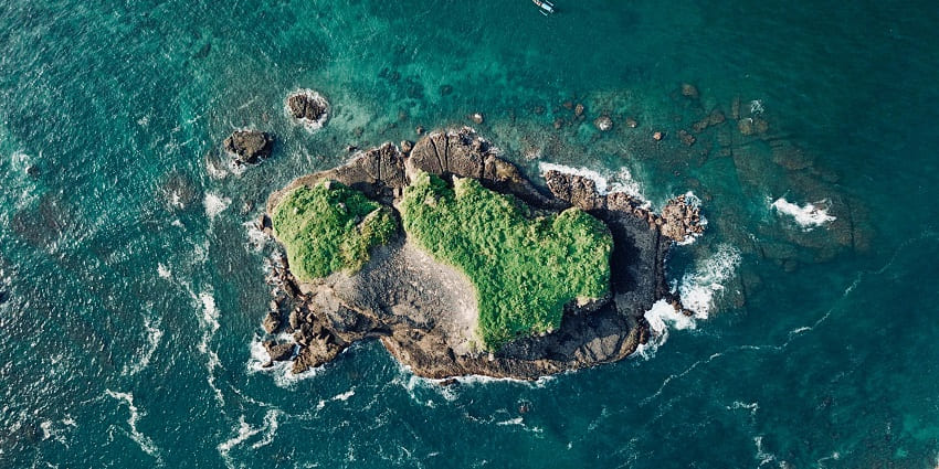An aerial view of a coral island is among the best places near Katmai
