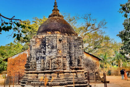 Image of Koteshwar temple surrounded by lush greenery during day time